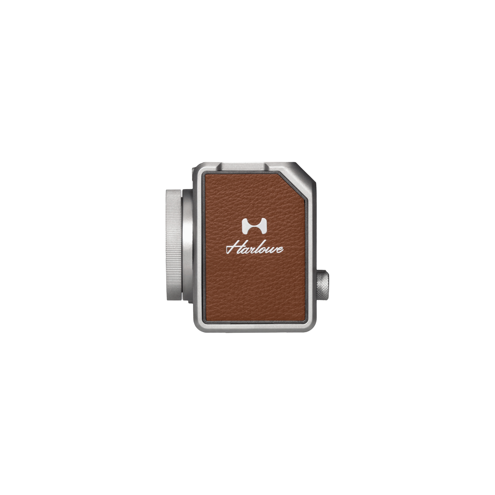 Hobolite Micro 8W LED light with silver body and brown leather panel showing Harløwe branding for product appearance.
