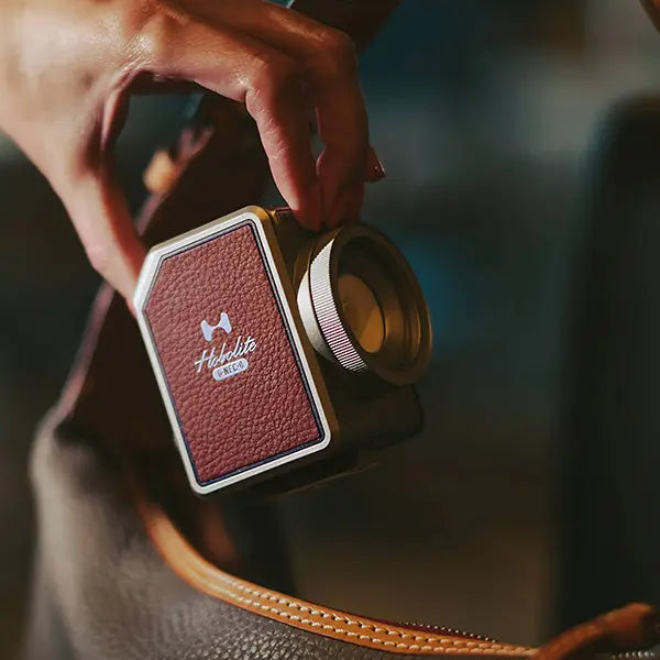 Hobolite Micro portable LED light with brown leather panel, highlighting premium design and compact size.