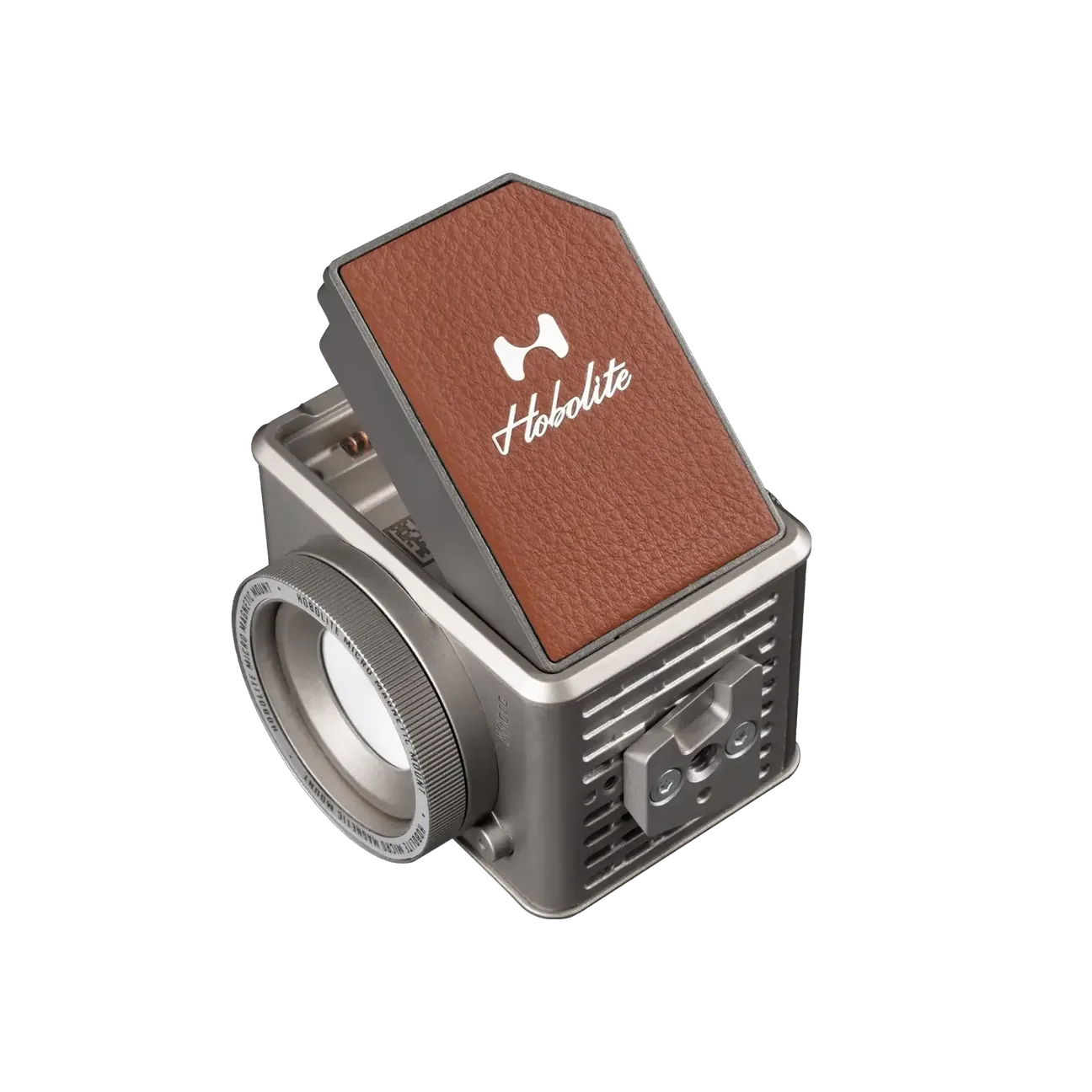 Compact Hobolite Micro portable LED light with silver metal body and brown leather panel on black background.