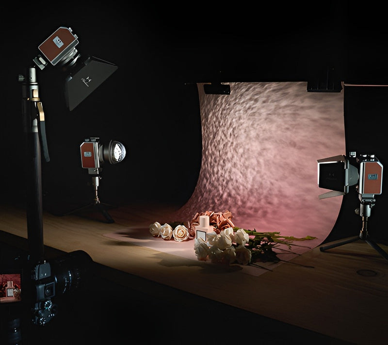 Harlowe Mini II lights illuminate a tabletop floral shoot against a textured backdrop. 