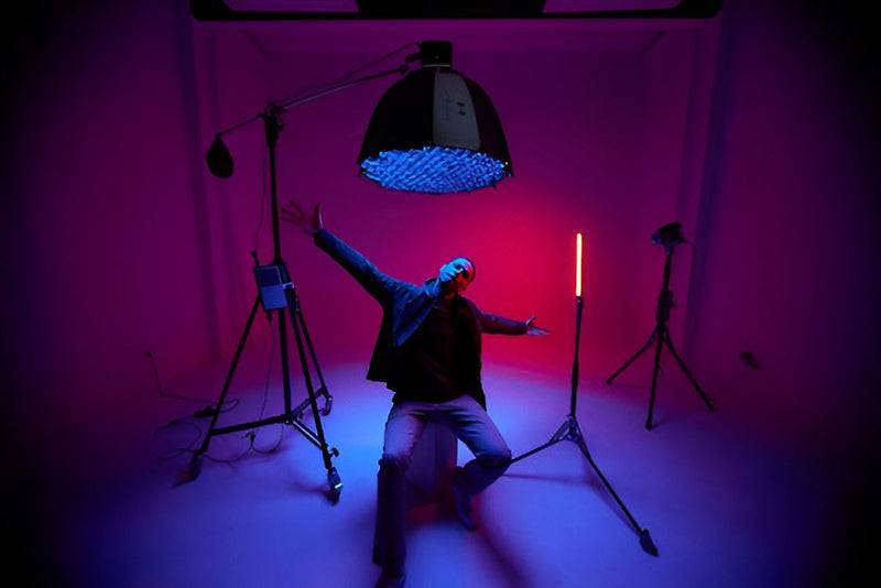 Harlowe Pro 300W Spectra RGBCW Studio Light Kit, overhead lighting a seated subject on a magenta set.