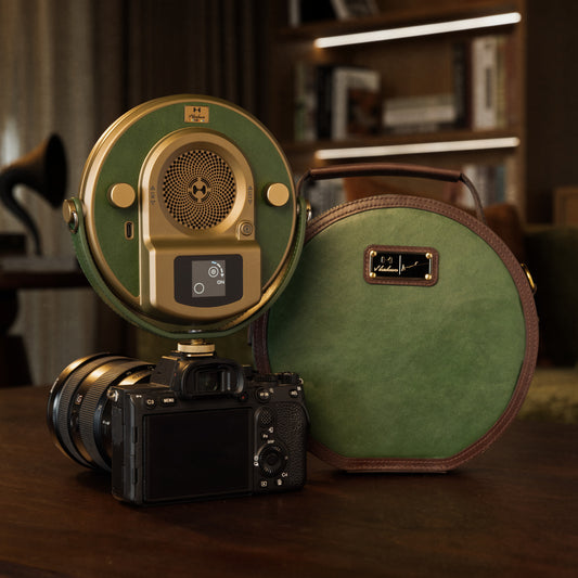Harlowe X Adele Chan Sol 30W Spectra Creator Kit on a wooden table with its signature round deep pine green carry bag and a mirrorless camera