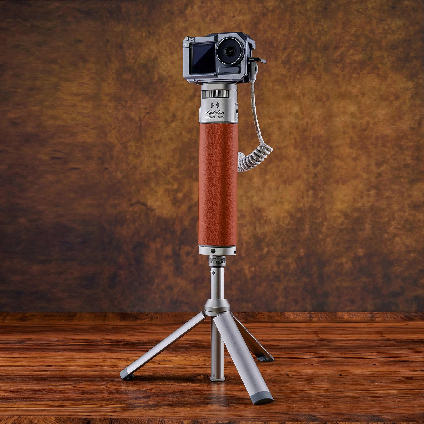 Harlowe Extendable Desktop Tripod Light Stand with camera mount and leather-wrapped column on wooden surface.