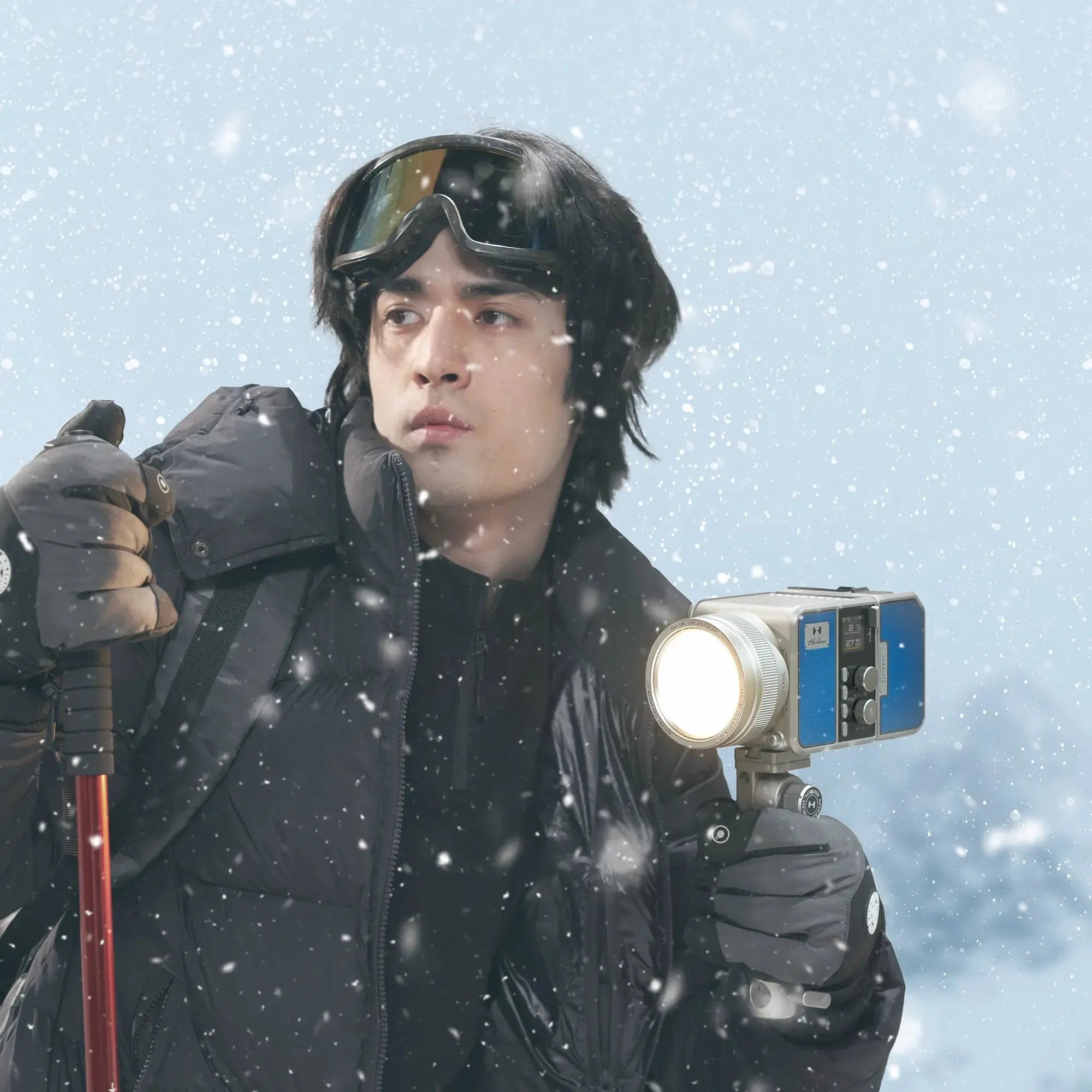 Max-X 80W portable LED light kit for videography in snow, held by person in winter gear.
