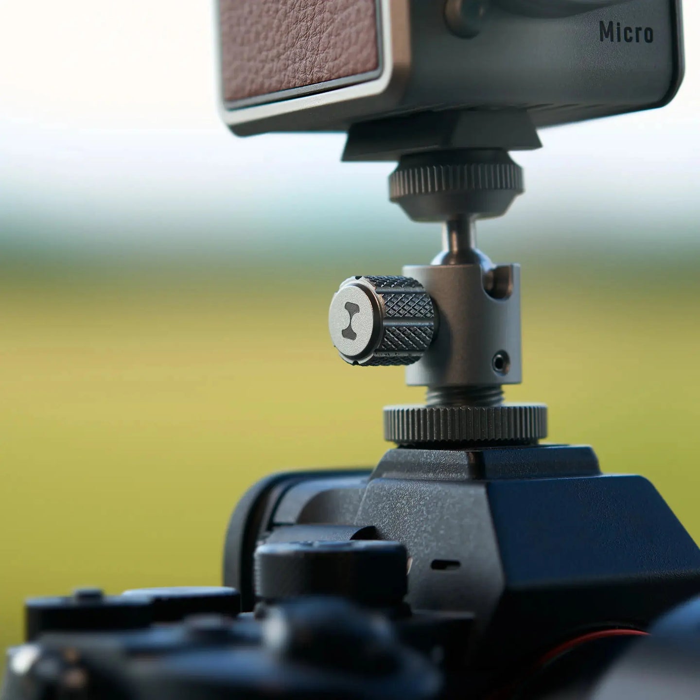 Harlowe Ballhead Cold Shoe Adapter securely mounted on camera, showing adjustable ball joint and textured knob.