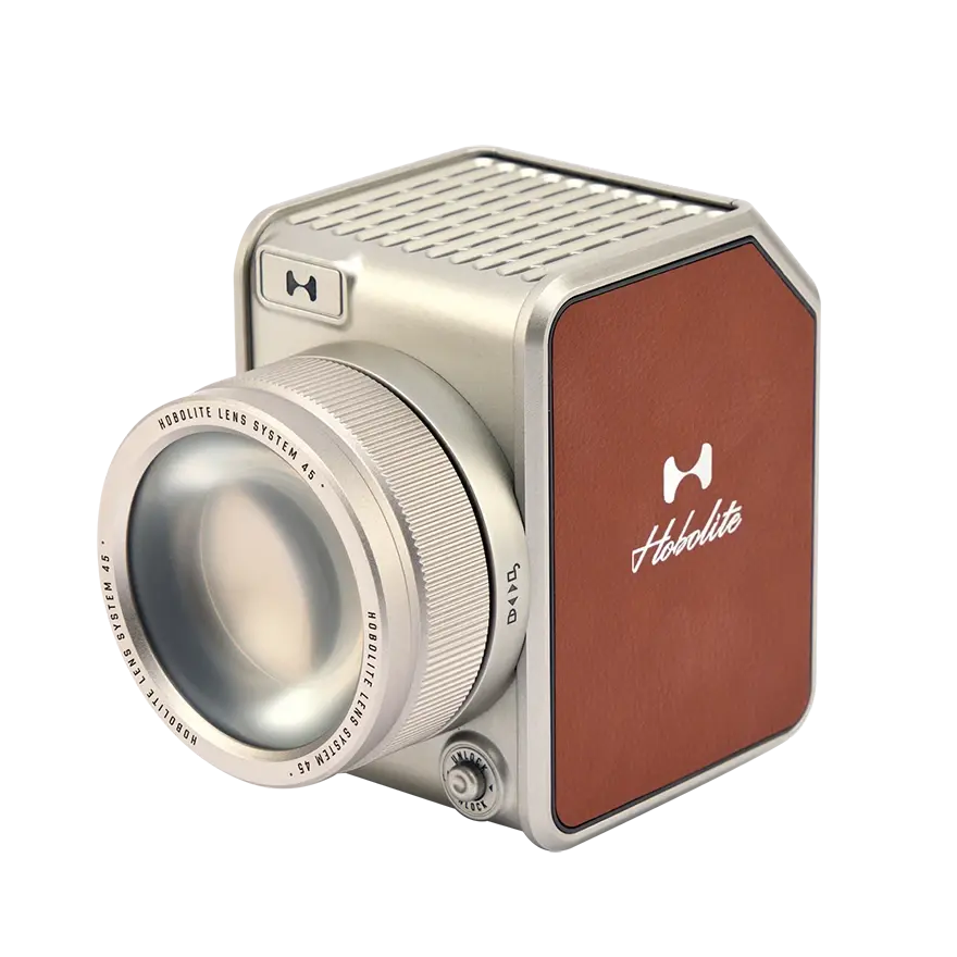 Hobolite Avant Lens System in silver with a clear glass lens, textured metallic rim, and brown leather panel featuring the Hobolite logo.