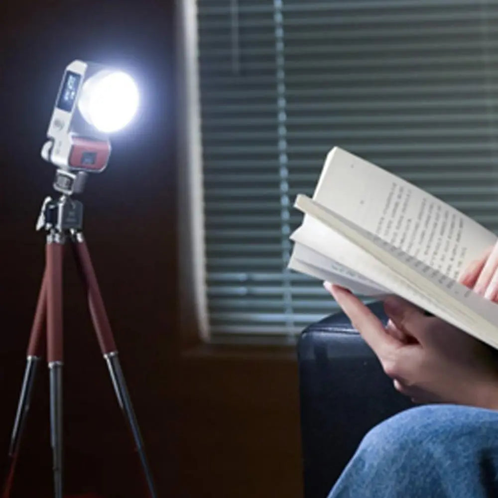 Harlowe Iris 5W Spectra LED light on tripod illuminating a book for content creation.