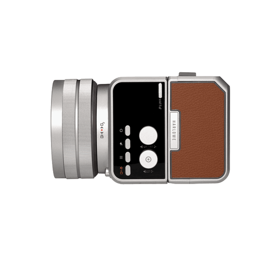 Silver mirrorless camera with brown leather grip and prominent lens, ideal for photography and videography.