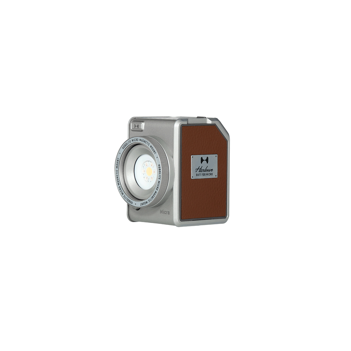 Harlowe Micro 8W RGBCW LED light, compact silver body with brown leatherette panel and brand logo, adjustable lens.