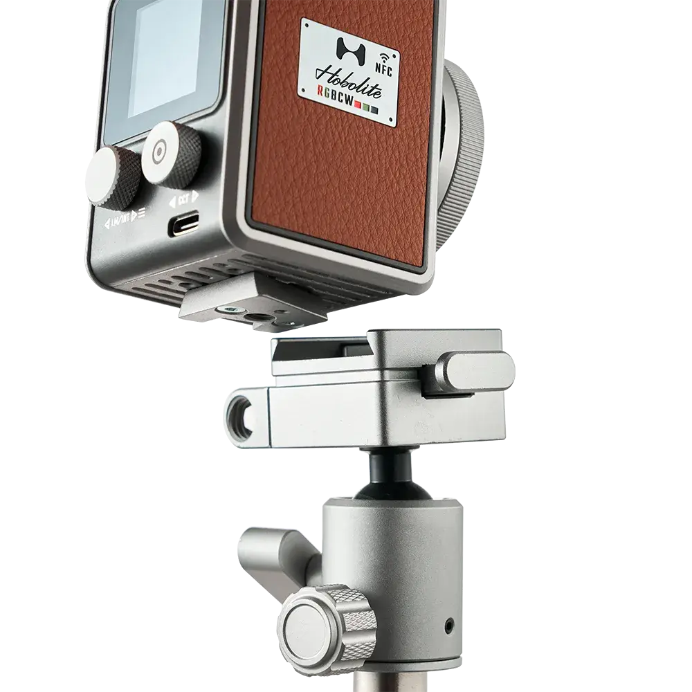 Harlowe Micro RGBCW LED light with leatherette panel mounted on silver adjustable bracket, showcasing mounting versatility.