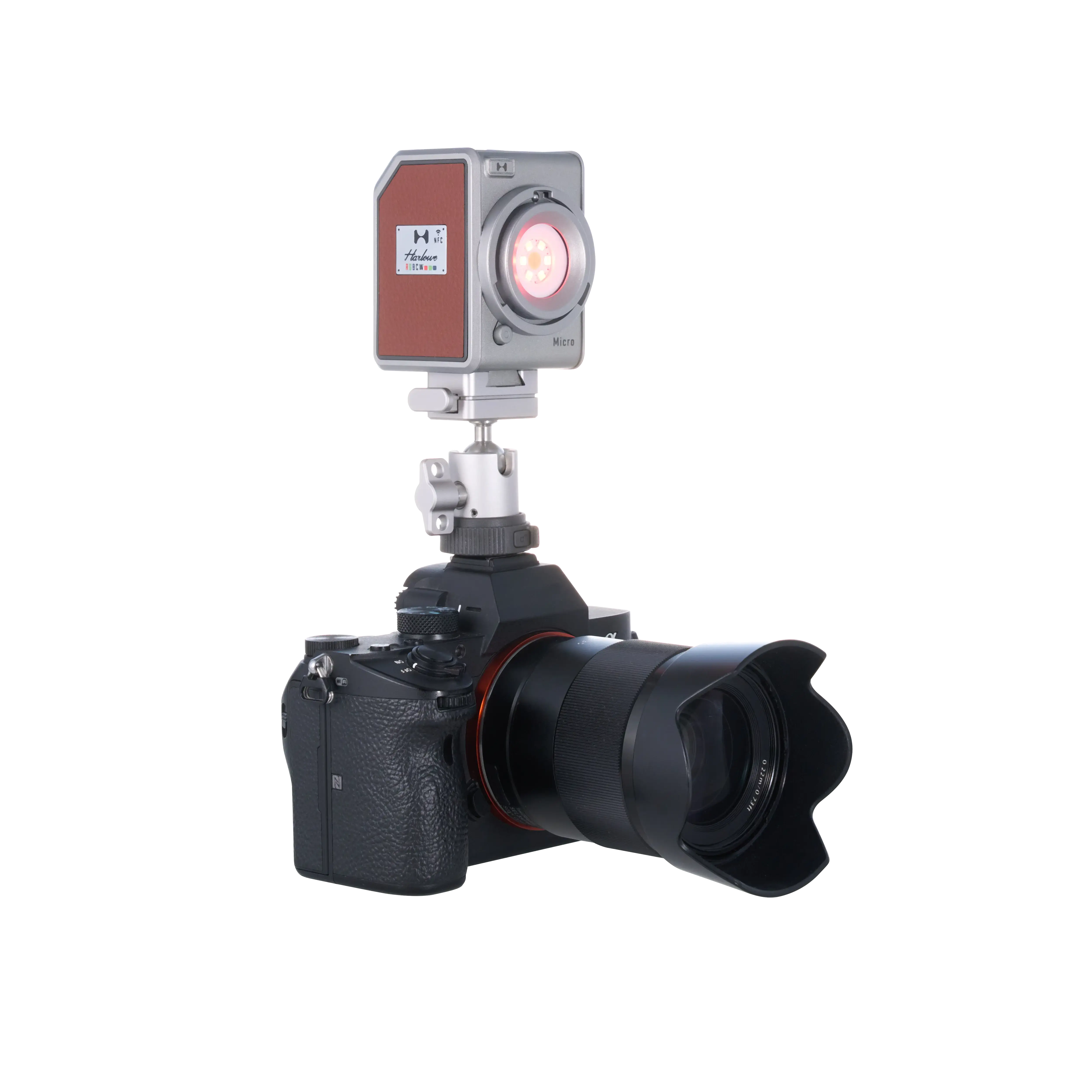 Compact Harlowe Micro 8W RGBCW LED light mounted on professional camera with adjustable mount.