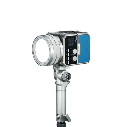 Harlowe Max-X 40W professional LED video light with silver body, circular lens, digital controls, and blue accent panel, mounted on adjustable stand.
