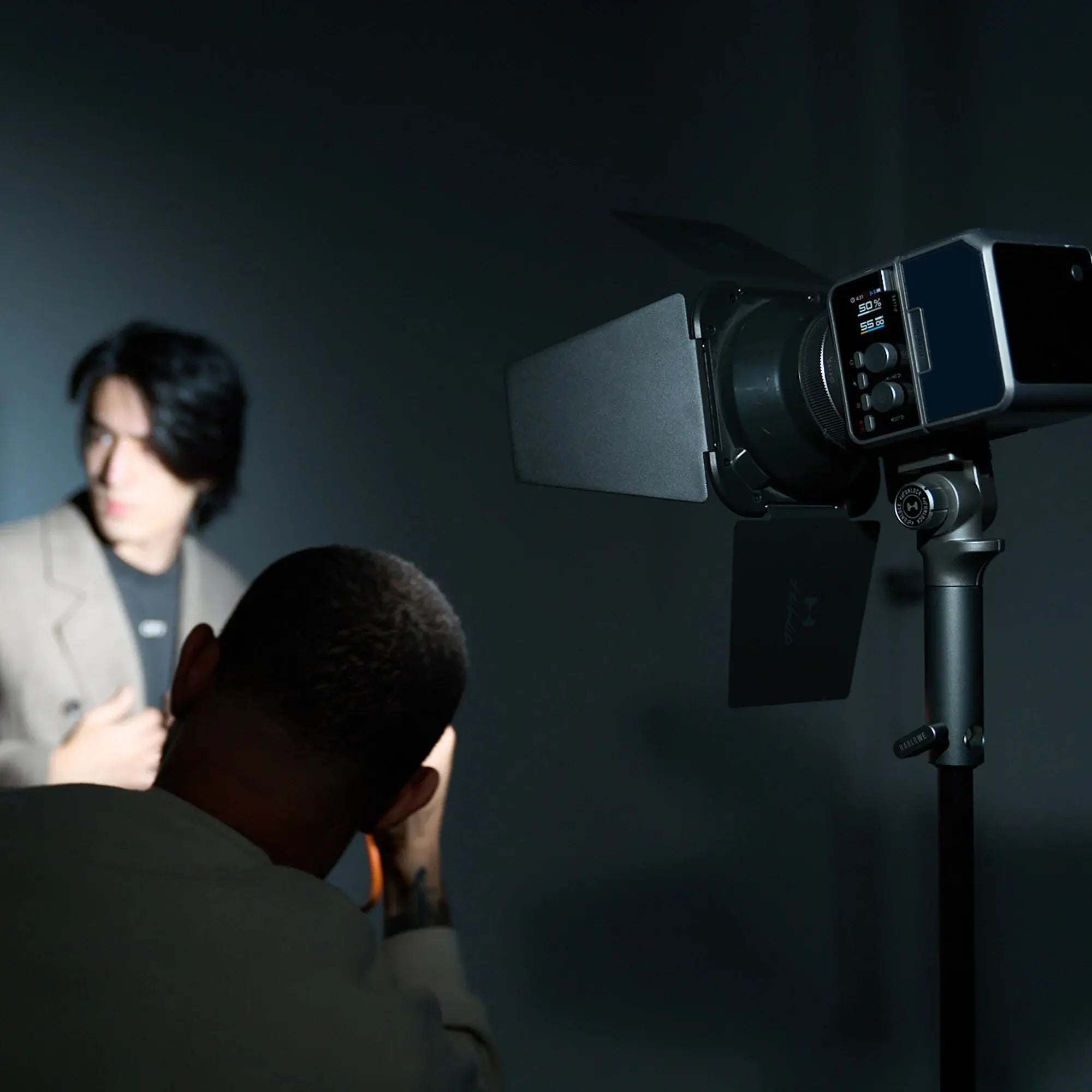 Harlowe Max-X 40W LED video light with barn doors on adjustable stand in professional studio setup.