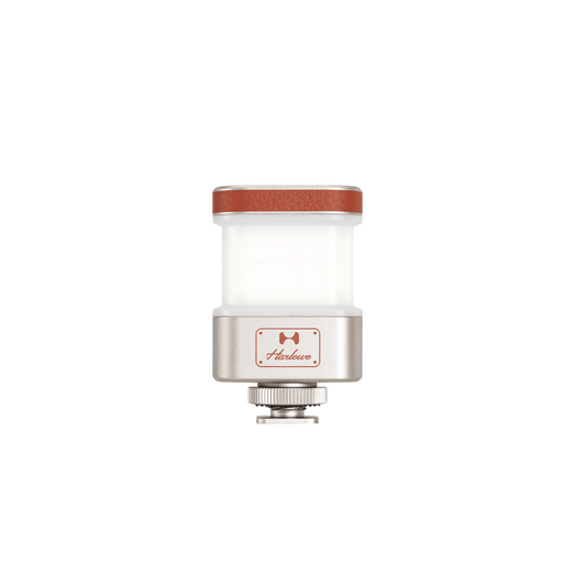 Harlowe Omni 360° fill light front view: frosted diffuser, red leather top, silver logo base and cold shoe
