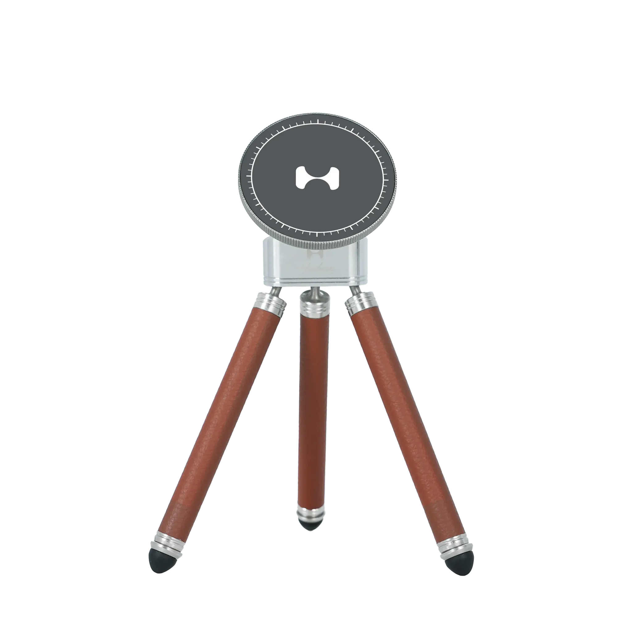 Compact MagSafe tabletop tripod with dark grey magnetic top, brown leather-textured legs, and silver adjustable mounting hardware for mobile content creators.
