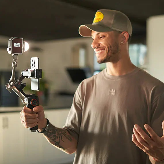 Harlowe Micro LED light on camera gimbal with smartphone for vlogging and content creation.
