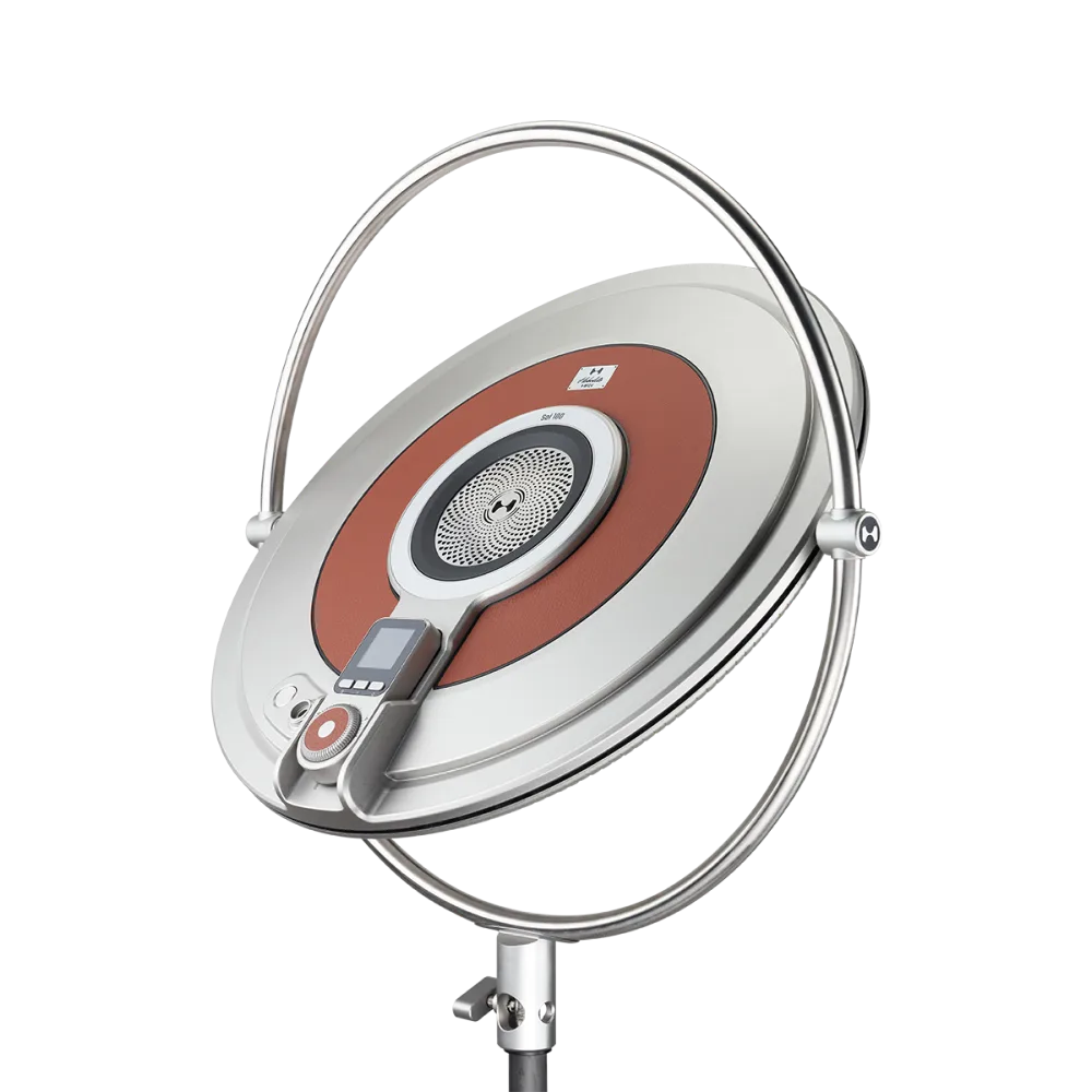 Harlowe Sol 100W professional LED panel light with sleek silver circular design, rust accent ring, and adjustable mounting stand.